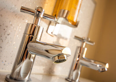 Photograph of chrome taps and complimentary handwash
